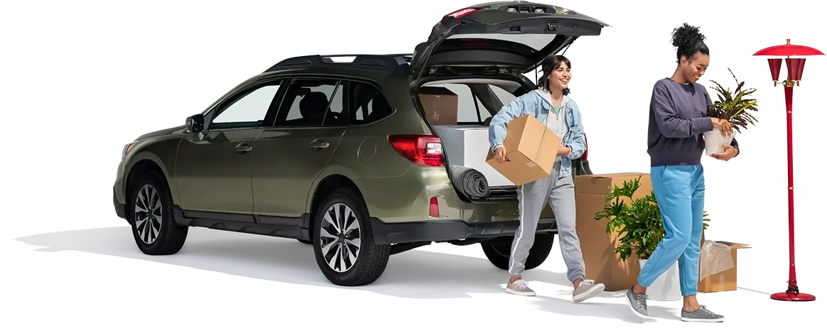 A mother and daughter remove household items from their SUV.